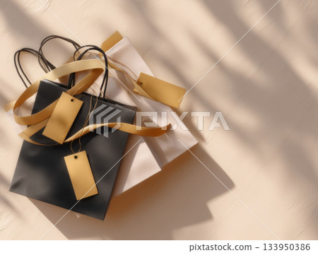 Gift bags with gold ribbons on beige 133950386