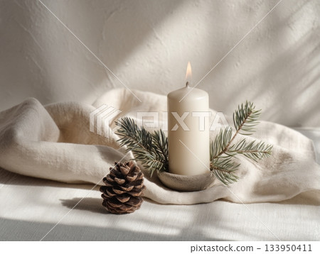 Christmas candle and pine on beige fabric 133950411