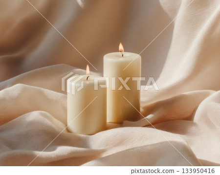 Two lit candles on linen soft minimal setup Two lit candles on linen soft minimal setup 133950416