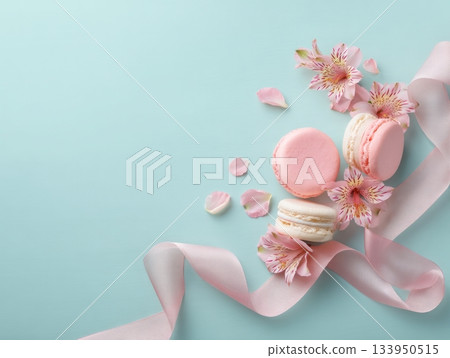 Macarons with ribbon and flowers on mint background Macarons with ribbon and flowers on mint background 133950515