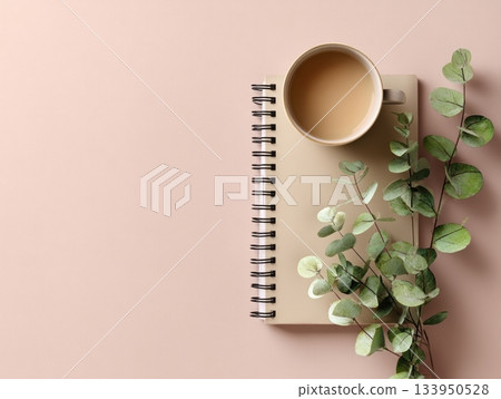 Coffee cup with notebook and eucalyptus leaves Coffee cup with notebook and eucalyptus leaves 133950528