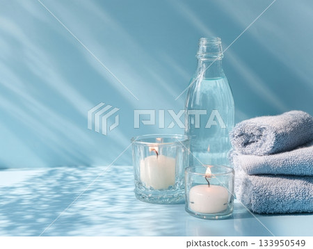 Minimal spa setup with water bottles and candle Minimal spa setup with water bottles and candle 133950549