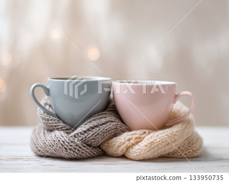 Two ceramic cups with wool scarf cozy scene Two ceramic cups with wool scarf cozy scene 133950735