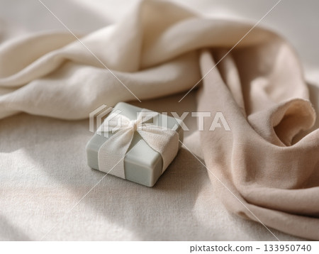 Wrapped gift box with ribbon on fabric 133950740