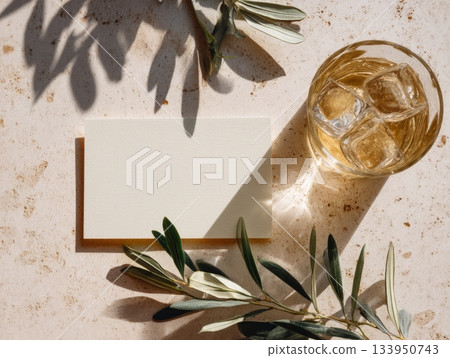 Olive Branch Mockup with Blank Card and Iced Drink on Stone Background 133950743