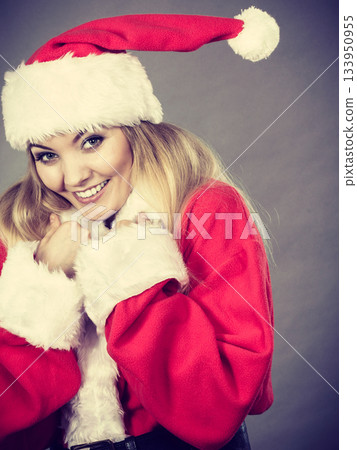 Happy woman wearing Santa Claus helper costume 133950955