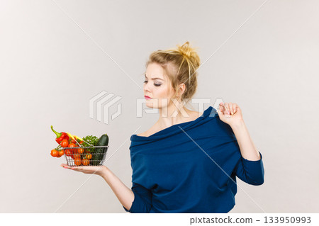 Woman with vegetables, thinking face expression Woman with vegetables, thinking face expression 133950993
