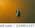Boat with Person on Glittering Water 133951337