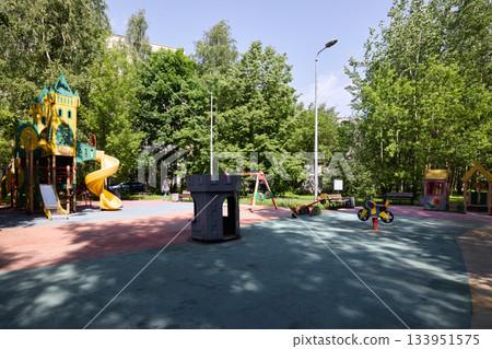 Playground with features, Community leisure zone featuring colorful structures and shaded greenery 133951575