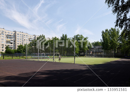 Deserted athletic area, Silent recreational space amid cityscape and residential structures 133951581