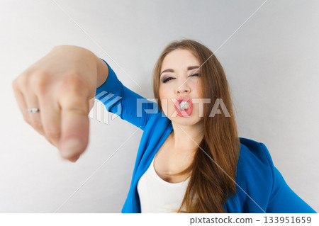 Funny woman face close up pointing Funny woman face close up pointing 133951659