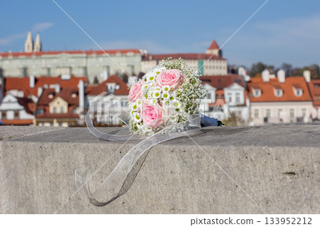 Wedding bouquet resting on a wall overlooking prague 133952212