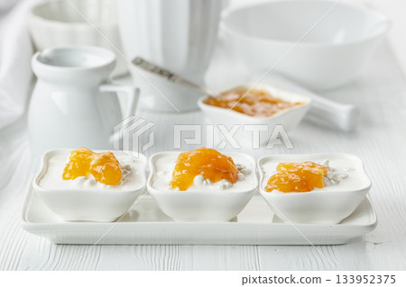 Cottage cheese with cream and apricot jam. 133952375