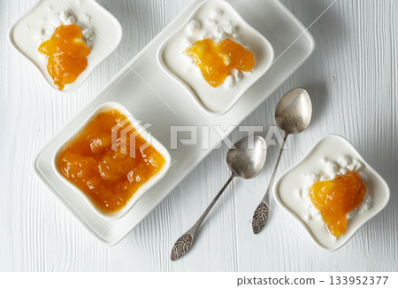 Cottage cheese with cream and mango jam. 133952377