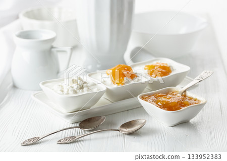 Apricot or mango jam and cottage cheese. 133952383