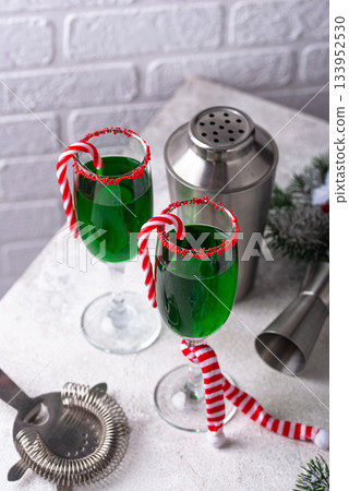 Christmas green cocktail punch with candy cane Christmas green cocktail punch with candy cane 133952530