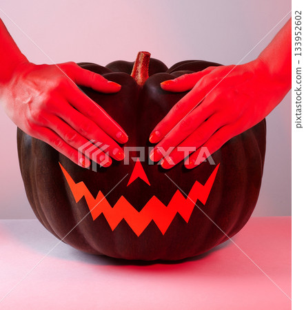 Halloween Pumpkin with Paper Cut Scary Face in red light. Jack Halloween. Smile Jack Pumpkin 133952602