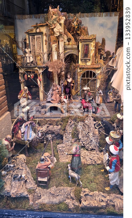 Traditional Christmas nativity scene display with figurines and rustic architecture. A nativity scene in a shop window. Christmas belen 133952839