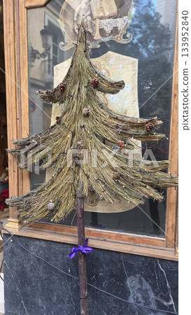 Rustic Christmas tree decor outside shop for holiday spirit and seasonal design Rustic Christmas tree decor outside shop for holiday spirit and seasonal design 133952840