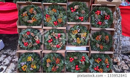 Festive christmas wreath display with pinecones and berries for holiday decoration. Christmas market 133952841