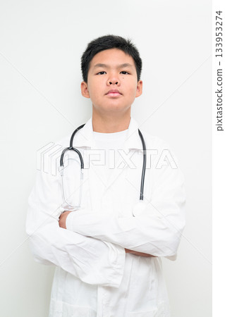 Young Asian Boy Dressed as Doctor with Stethoscope Arms Crossed Young Asian Boy Dressed as Doctor with Stethoscope Arms Crossed 133953274