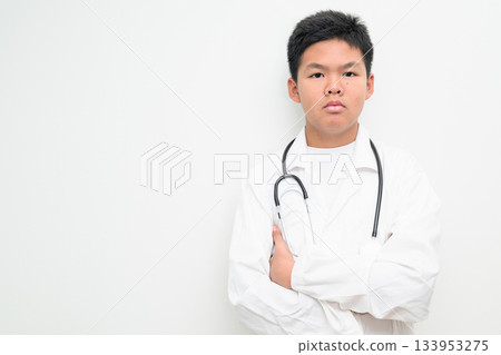 Young Asian Boy Dressed as Doctor with Stethoscope Arms Crossed Young Asian Boy Dressed as Doctor with Stethoscope Arms Crossed 133953275