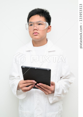 Young Asian Boy Dressed as Scientist with Lab Coat Using Digital Tablet Computer Young Asian Boy Dressed as Scientist with Lab Coat Using Digital Tablet Computer 133953313