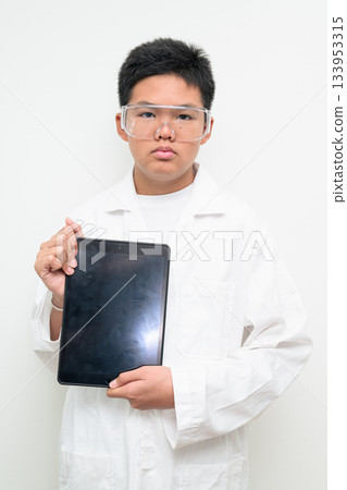 Young Asian Boy Dressed as Scientist with Lab Coat Showing Digital Tablet Computer Screen Young Asian Boy Dressed as Scientist with Lab Coat Showing Digital Tablet Computer Screen 133953315