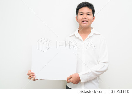 Asian Teenage Boy Student Studio Portrait on White Background Showing Empty Placard with Copy Space Asian Teenage Boy Student Studio Portrait on White Background Showing Empty Placard with Copy Space 133953368