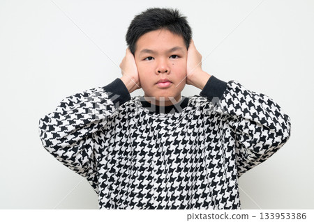 Asian Teenage Boy Studio Portrait on White Background Hands Covering Ears Asian Teenage Boy Studio Portrait on White Background Hands Covering Ears 133953386