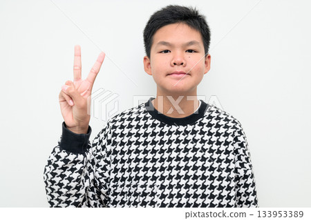 Asian Teenage Boy Studio Portrait on White Background Peace Sign Gesture Asian Teenage Boy Studio Portrait on White Background Peace Sign Gesture 133953389