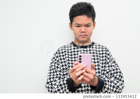 Asian Teenage Boy Studio Portrait on White Background Using Phone 133953412
