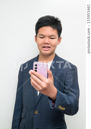 Asian Teenage Boy in Suit Studio Portrait Using Mobile Phone Asian Teenage Boy in Suit Studio Portrait Using Mobile Phone 133953461