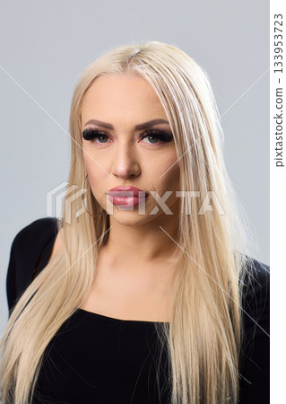 Sophisticated portrait of poised woman in professional studio environment, Refined image showcasing confident lady with braided hairstyle dressed elegantly against studio backdrop Sophisticated portrait of poised woman in professional studio environment, Refined image showcasing confident lady with braided hairstyle dressed elegantly against studio backdrop 133953723
