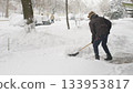 Worker Clears Deep Snow From Outdoor Walkway In Winter 133953817