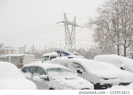 Vehicles Buried In Snow With Transmission Tower In Background 133953821
