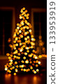 A Christmas tree is lit up with lights in the dark 133953919