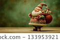 A Santa Claus figurine carrying a bag of presents on his back 133953921