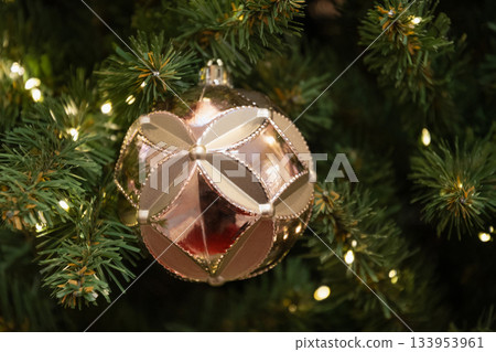 Golden Christmas ornament with warm lights creating soft festive luxury decor. Xmas card. Close up. Golden Christmas ornament with warm lights creating soft festive luxury decor. Xmas card. Close up. 133953961