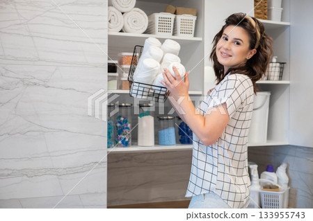 Woman housewife white bathroom general cleaning cupboard shelves storage organizing eco minimalism Woman housewife white bathroom general cleaning cupboard shelves storage organizing eco minimalism 133955743