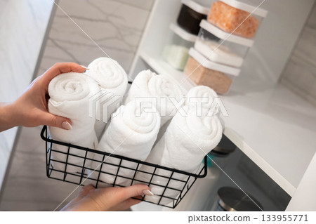 Woman housewife white bathroom general cleaning cupboard shelves storage organizing eco minimalism 133955771