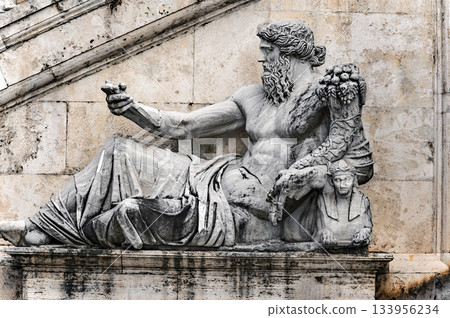 Ancient Statue in front of stairs into Palazzo Senatorio in Rome, Italy. 133956234