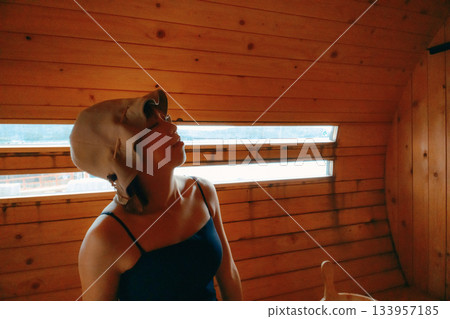 A woman relaxing in the sauna A woman relaxing in the sauna 133957185