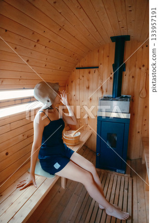 A woman relaxing in the sauna 133957191