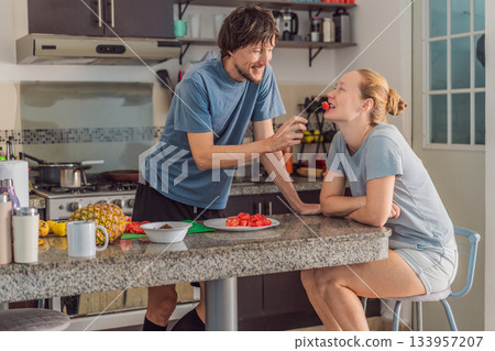 Woman and man preparing breakfast together in a bright kitchen, enjoying a warm morning routine. Home lifestyle, teamwork and cozy everyday living concept, reflecting connection, cooperation and a 133957207