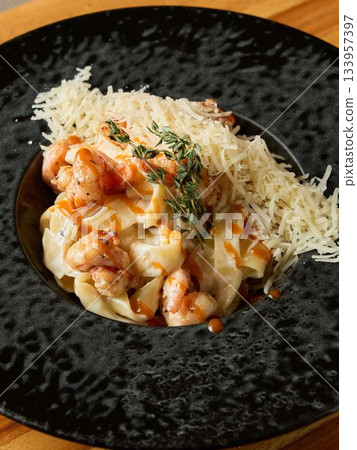 Comforting lobster pasta presentation, Hearty lobster pasta served with fragrant herbs and creamy sauce Comforting lobster pasta presentation, Hearty lobster pasta served with fragrant herbs and creamy sauce 133957397
