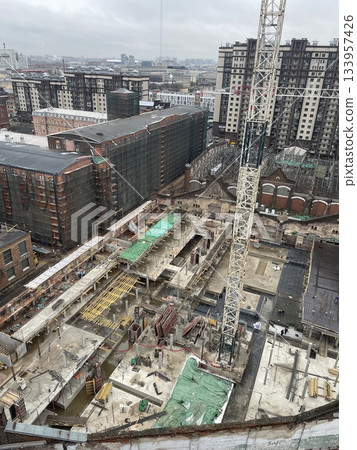 Urban construction assessment, Cityscape with building frameworks and safety covers observed Urban construction assessment, Cityscape with building frameworks and safety covers observed 133957426