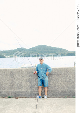 Senior man looking at fishing rod Senior man looking at fishing rod 133957449