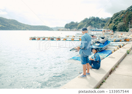 一對老年夫婦在海灘上享受釣魚的背影 一對老年夫婦在海灘上享受釣魚的背影 133957544