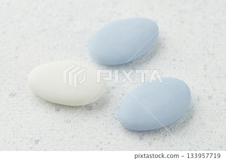 Traditional Easter Portuguese candies. White and blue sweets on grey background 133957719